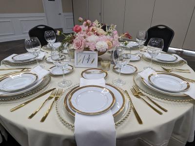 Eight person formal dining set up at a round table