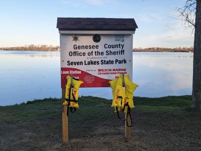 Sign posted at Lake Ponemah Boat Launch with rentable life jackets